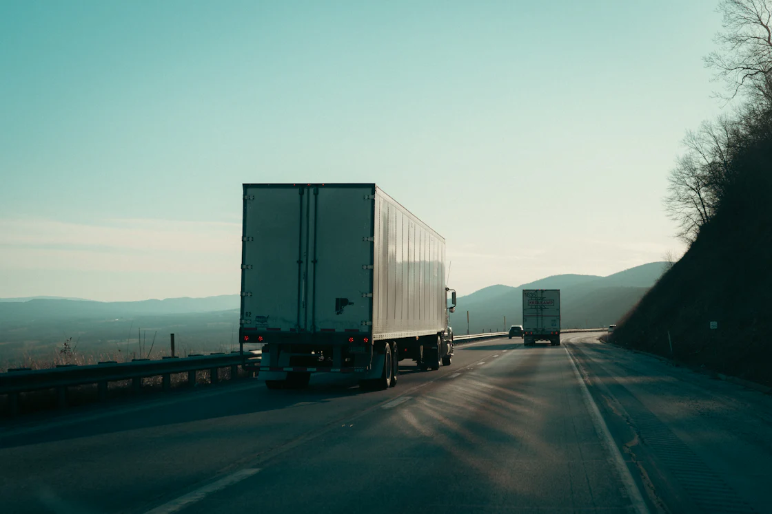 Two tractor-trailers on a divided highway