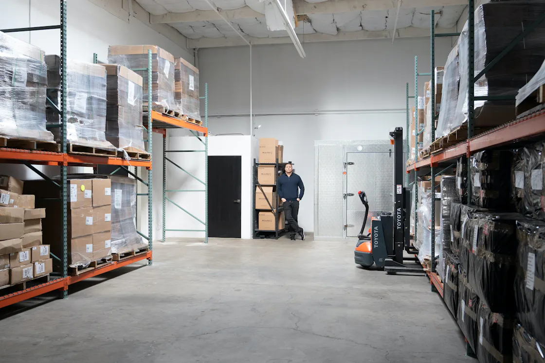 Stretch-wrapped pallets of boxed freight on warehouse racking